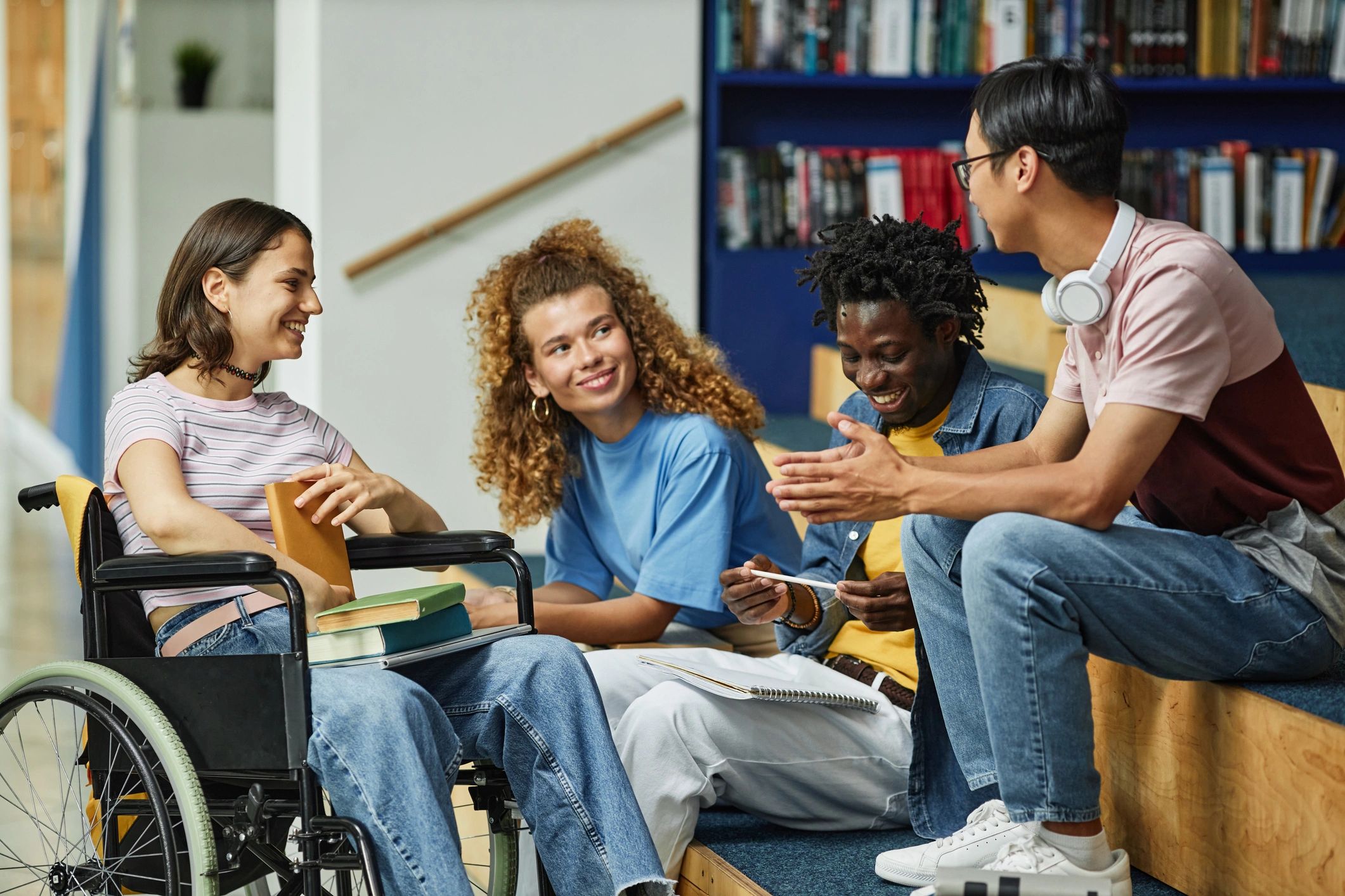 Diverse students discussing ideas in a college library