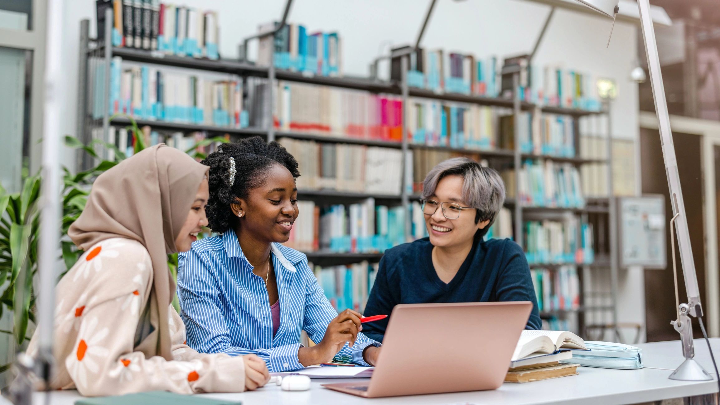 Students and collaborators studying together in a library