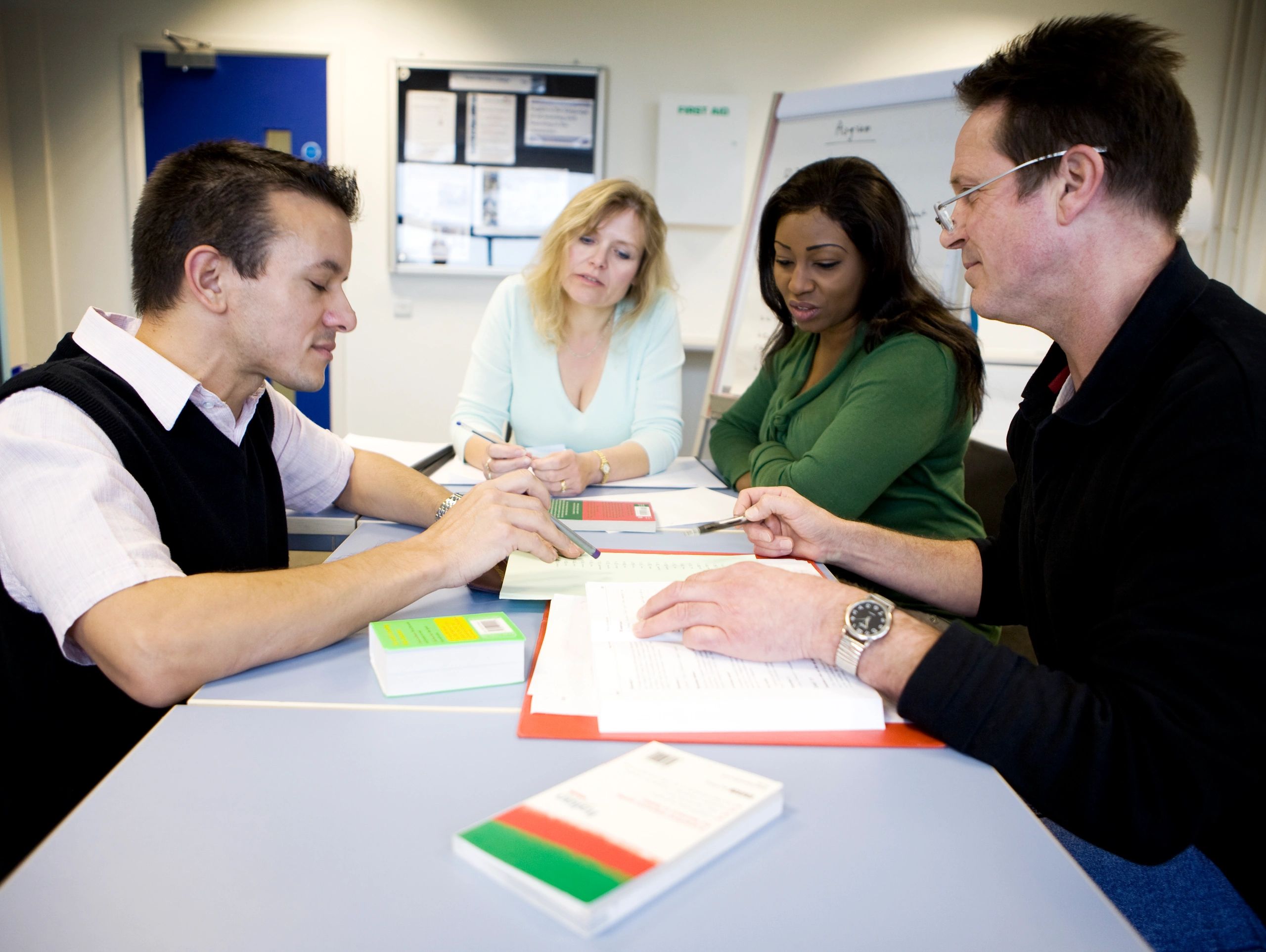 Adult learners collaborating during an education session